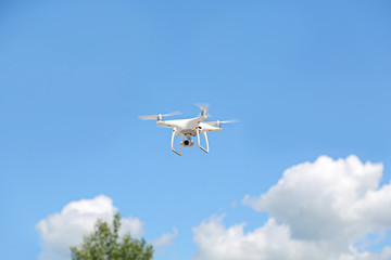 drone copter flying with digital camera on a clear blue sky