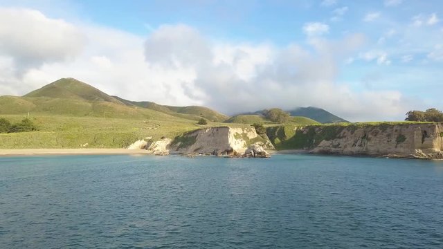 310 Big Sur aerial flying over the water reveling cliffs and mountains and clouds