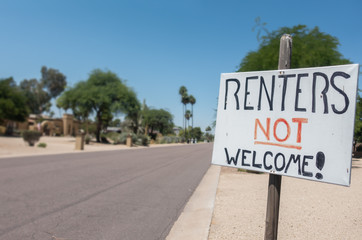 Renters Not Welcome Sign Concept Image on residential street.   Unhappy neighbors create a notice to show their anger at noise and anti social behavior from vacationers staying on the street.