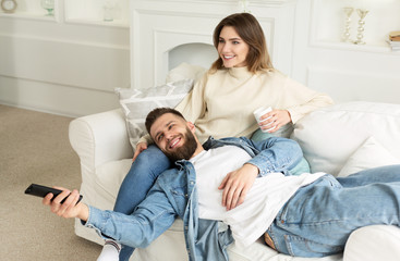 Loving Couple Watching Tv Together, Relaxing At Home