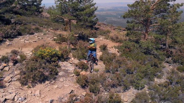 Mountain cyclist resting on a mountain road, aerial plane from drone