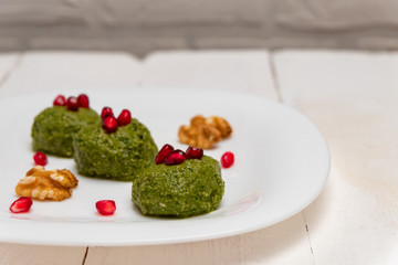 Traditional Georgian dish pkhali made of spinach, walnuts, vinegar, onions, garlic and herbs. Image with copy space.