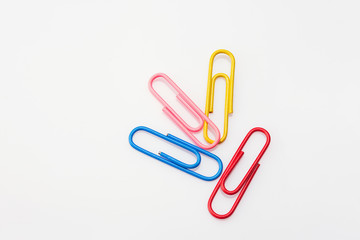 Multi-colored paper clips  on a white background. Selective focus. Close up.