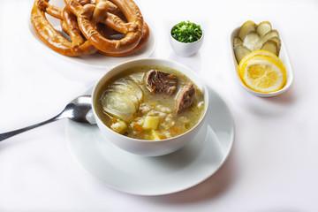 Soup Rassolnik with pickled cucumber and sour cream on a white background. Russian cuisine. Close up. Selective focus. For the menu.