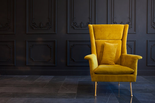 Stylish Bright Yellow Chair Against A Dark Gray Wall