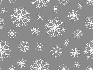 Fototapeta na wymiar Pattern with white snowflakes of different shapes on a gray background