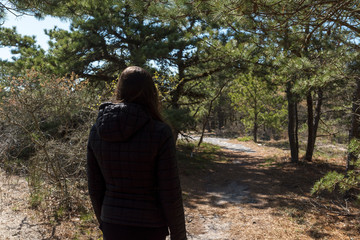 a woman looks at the trail ahead