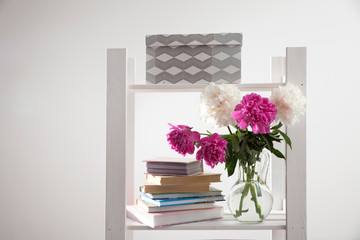 Fragment of a bright children's room with white bookcase and a chair