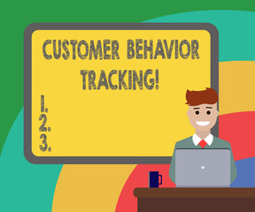 Conceptual hand writing showing Customer Behavior Tracking. Business photo showcasing Action that a user takes related to your company Bordered Board behind Man Smiling with Laptop Mug on Desk