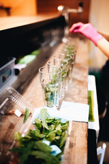 Eight mojito cocktails on the bar counter