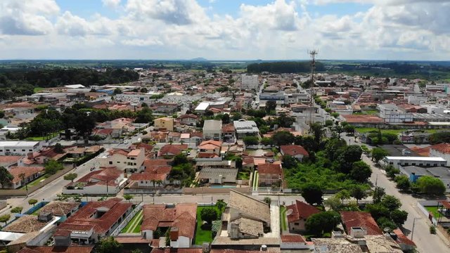 Aerial establishing shot of a typical south america downtown at Cruz das Almas, Bahia, Brazil. Show houses, small buildings in the neighborhood, and green environnement. 
