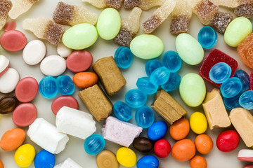 multicolored caramel candies scattered on the table background. sugar products. colored sweets