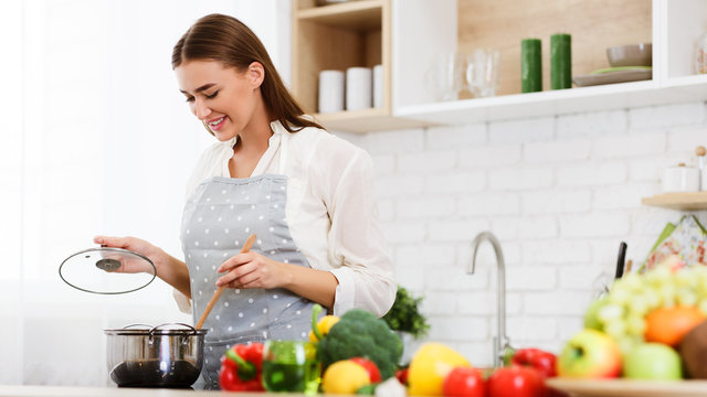 Happy Woman Cooking Dinner In Kitchen, Stiring Soup