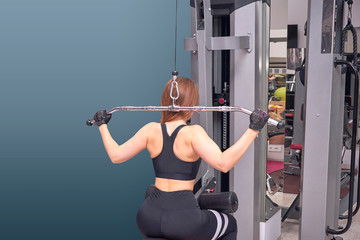 Fototapeta premium Woman trains in the gym