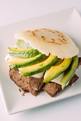 Arepa llanera, South American food on white plate