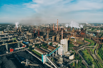 Air pollution concept. Aerial view of industrial zone with many smoke stacks with smoke