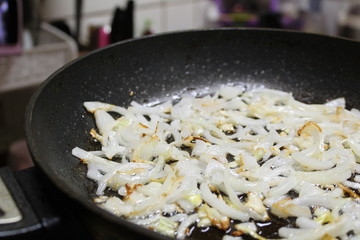 photo of fried onions on a frying pan