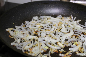 photo of fried onions on a frying pan
