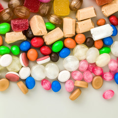 Fototapeta na wymiar multicolored caramel candies scattered on the table background. sugar products. colored sweets