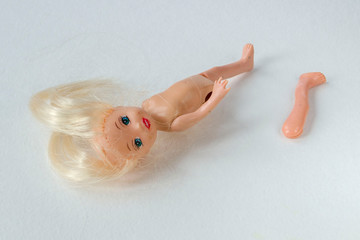 broken doll on white background