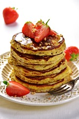 Paleo hazelnut pancakes with honey and strawberry. Gluten and sugar free pancakes