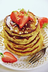 Paleo hazelnut pancakes with honey and strawberry. Gluten and sugar free pancakes