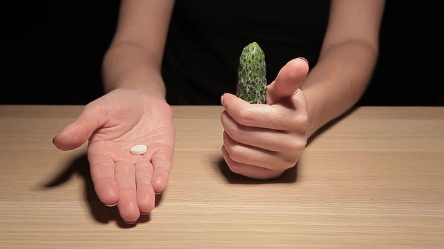 woman hand cucumber pill table hd footage 