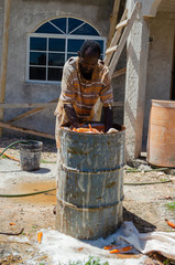 Man Washing Carrots In Drum