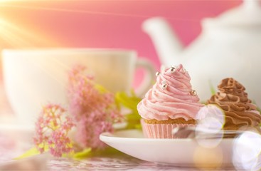 Delicious cupcakes with cream and tea set
