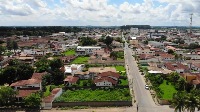 Aerial establishing shot of a typical south america downtown at Cruz das Almas, Bahia, Brazil. Show houses, small buildings in the neighborhood, and green environnement. 