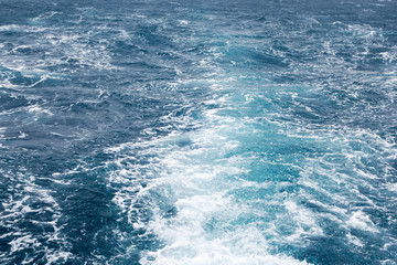 Fototapeta na wymiar Water wake of cruise liner blue sea splash background.