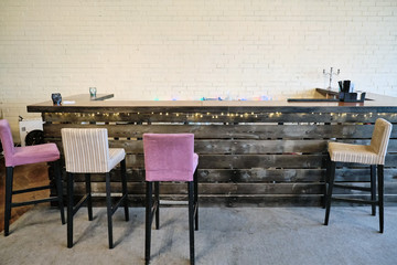 Empty vintage bar in the afternoon. Chairs and bar counter in the cafe without people. A loft-style establishment.