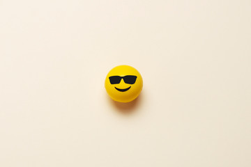 Smiling emoticon ball with sunglasses