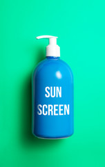 Sun screen bottle on turquoise background, coneptual idea. Sun protection