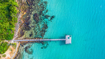 Aerial view of wood pier in to the sea and ocean for travel and vacation.