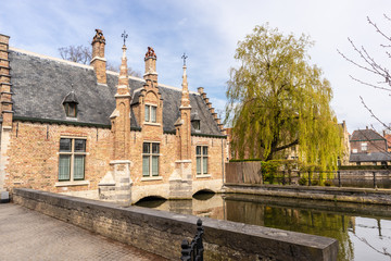 Bruges, Belgium - APRIL 05, 2019: Minnewater lake and medieval castle in Bruges