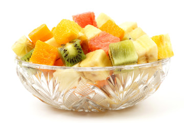 assorted fruit chopped in cubes on a plate on white background