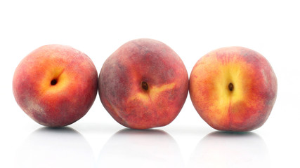 three ripe peach on a white background