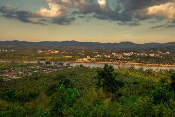 High mountain view background, able to see the surrounding natural atmosphere (communities on the waterfront, trees, water, sky) and wind blowing through the cool. 