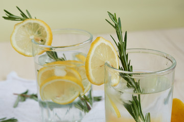Refreshing Summer Cocktail with Citrus Fruits and rosemary on a white napkin , close-up