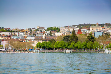 Fototapeta na wymiar View of Lausanne city taken from ferry boat on Lake Geneva in Switzerland 