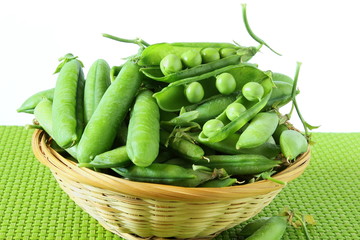fresh open green pea pods and green peas isolated on the white background