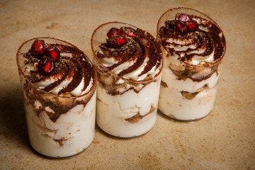 closeup three mousse desserts with pomegranate grains