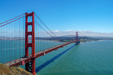 Fototapeta na wymiar Famous Golden Gate Bridge. Suspension bridge spanning the Golden Gate. The structure links the American city of San Francisco, California, the northern tip of the San Francisco Peninsula to Marin C