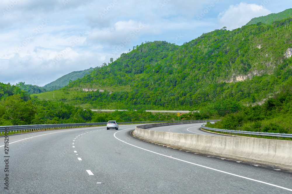 Wall mural two lane street/ double lane road on dual carriageway highway through scenic countryside mountain la