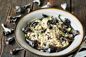 black chanterelle risotto. Black Trumpet mushrooms recipe. Italian food. place for text. copy space.
