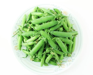 fresh green pea pods and green peas isolated on the white background