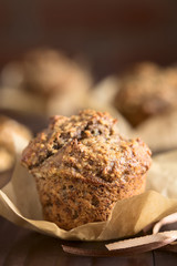 Fresh homemade oatmeal banana and walnut muffin, photographed with natural light (Very Shallow Depth of Field, Focus on the top front edge)