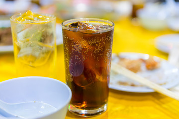 A glass of cola with ice cubes