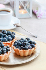 Blueberries cake and cup of coffee.